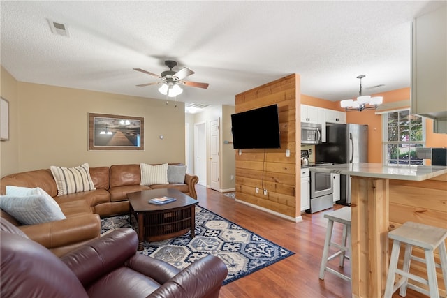 318 Weeping Willow Dr, Seneca, SC 29672 - living area with a chandelier, wood finished floors, ceiling fan, and a textured ceiling