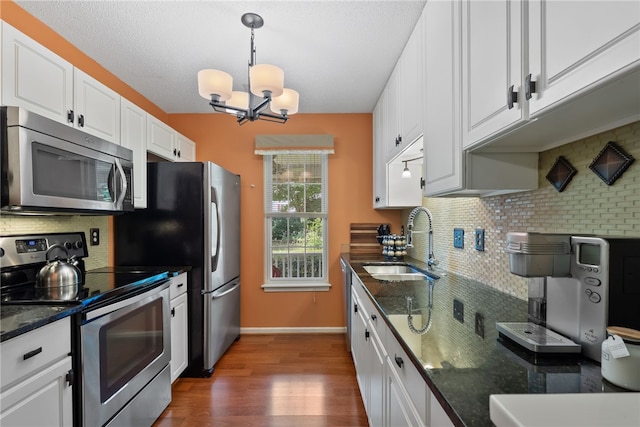 318 Weeping Willow Dr, Seneca, SC 29672 - kitchen featuring appliances with stainless steel finishes, backsplash, a chandelier, and white cabinets