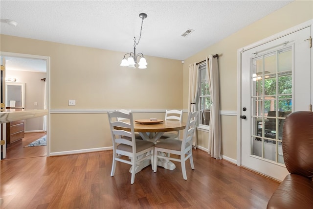 318 Weeping Willow Dr, Seneca, SC 29672 - dining space featuring wood finished floors, a chandelier, and a textured ceiling