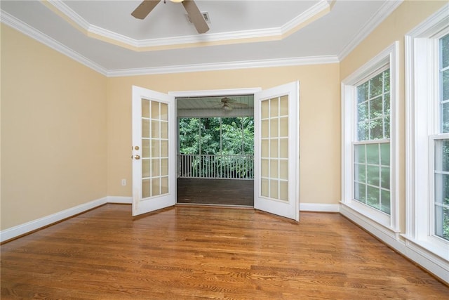 124 Bluestone Ct, Easley, SC 29642 - spare room with french doors, ceiling fan, wood finished floors, ornamental molding, and a tray ceiling
