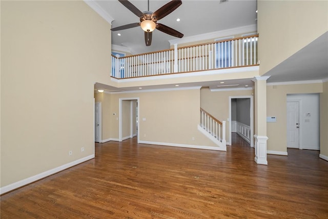 124 Bluestone Ct, Easley, SC 29642 - unfurnished living room featuring a ceiling fan, stairway, a high ceiling, wood finished floors, and crown molding