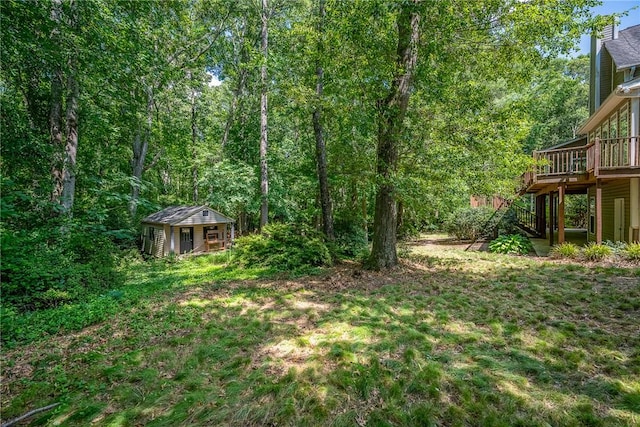 124 Bluestone Ct, Easley, SC 29642 - view of yard with a wooden deck, stairs, an outbuilding, and a view of trees