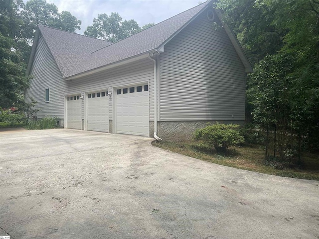 1298 Moorehead Pl, Pendleton, SC 29670 - view of side of home featuring concrete driveway, an attached garage, and roof with shingles