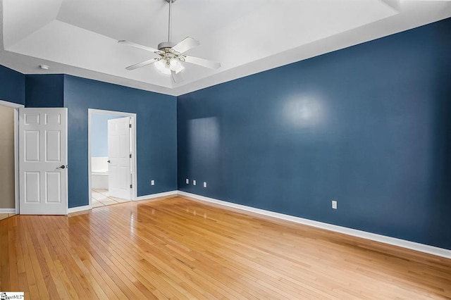 1298 Moorehead Pl, Pendleton, SC 29670 - unfurnished bedroom featuring light wood-style flooring, a raised ceiling, connected bathroom, and ceiling fan