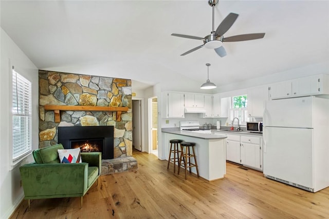 275 Lakeside Dr, Mountain Rest, SC 29664 - kitchen featuring freestanding refrigerator, range, vaulted ceiling, stainless steel microwave, and white cabinets