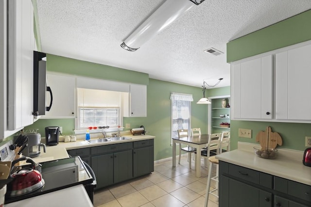 118 Nonna Ln, Seneca, SC 29678 - kitchen with a textured ceiling, white cabinetry, light tile patterned flooring, light countertops, and gray cabinets