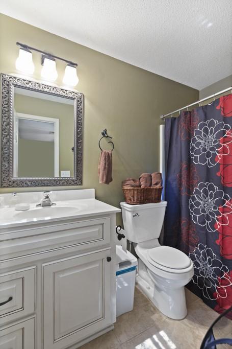 118 Nonna Ln, Seneca, SC 29678 - full bath featuring vanity, tile patterned floors, a textured ceiling, and curtained shower