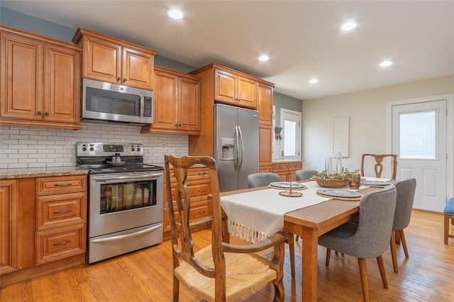 412 Singleton Rd, Anderson, SC 29625 - kitchen featuring stainless steel appliances, brown cabinets, light wood-style flooring, and recessed lighting