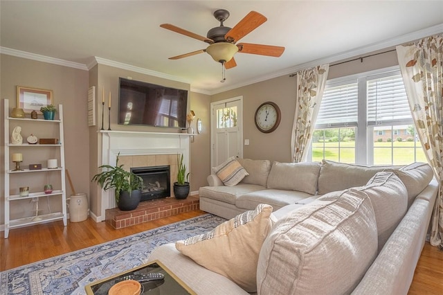 412 Singleton Rd, Anderson, SC 29625 - living room with wood finished floors, ornamental molding, ceiling fan, and a tiled fireplace
