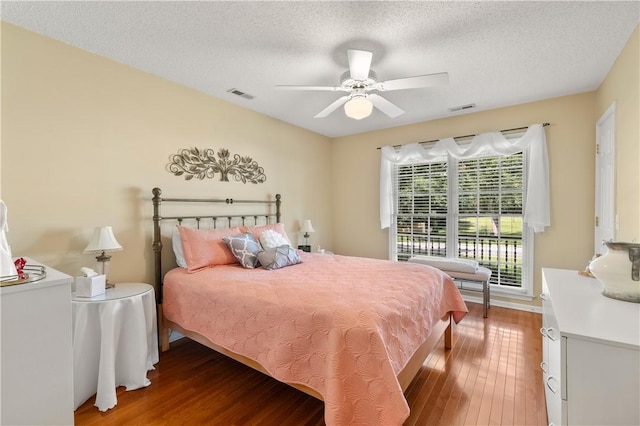 15067 Beacon Ridge Dr, Seneca, SC 29678 - bedroom featuring wood finished floors, a textured ceiling, and a ceiling fan