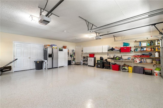 15067 Beacon Ridge Dr, Seneca, SC 29678 - garage with stainless steel refrigerator with ice dispenser, a garage door opener, and white fridge