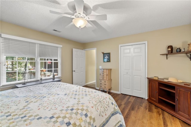15067 Beacon Ridge Dr, Seneca, SC 29678 - bedroom with a closet, wood finished floors, a ceiling fan, and a textured ceiling