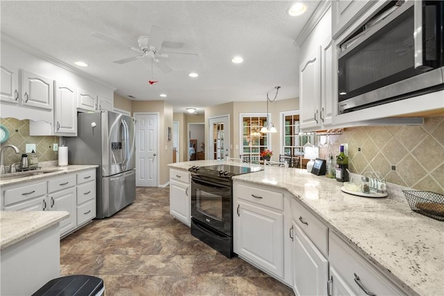 15067 Beacon Ridge Dr, Seneca, SC 29678 - kitchen featuring appliances with stainless steel finishes, recessed lighting, white cabinetry, a ceiling fan, and a peninsula