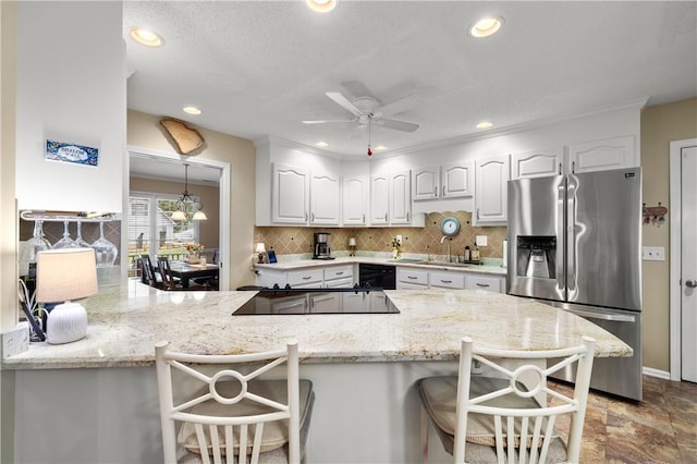 15067 Beacon Ridge Dr, Seneca, SC 29678 - kitchen with black appliances, white cabinets, a breakfast bar, a peninsula, and backsplash