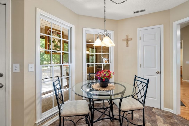 15067 Beacon Ridge Dr, Seneca, SC 29678 - dining space featuring plenty of natural light, a chandelier, and stone finish floors