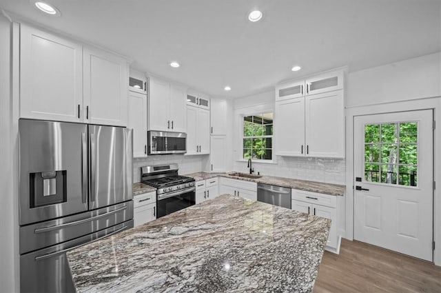 1205 Ramona Dr, Belton, SC 29627 - kitchen with appliances with stainless steel finishes, white cabinetry, light stone counters, decorative backsplash, and recessed lighting