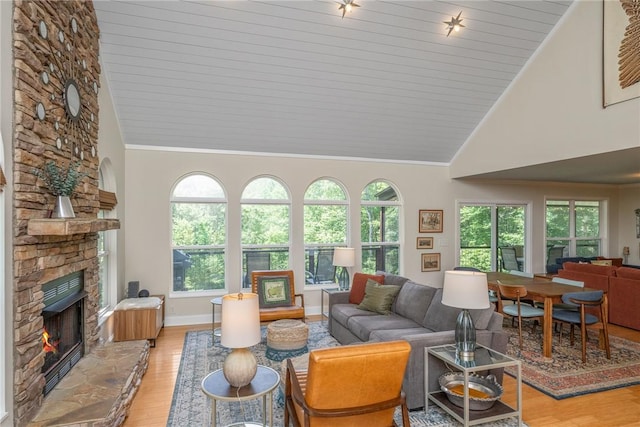 209 Falcon Crest Way, Pickens, SC 29671 - living room featuring high vaulted ceiling, light wood finished floors, a fireplace, ornamental molding, and wood ceiling