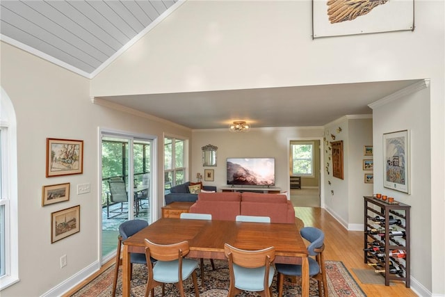 209 Falcon Crest Way, Pickens, SC 29671 - dining space featuring light wood-style floors, crown molding, plenty of natural light, vaulted ceiling, and arched walkways