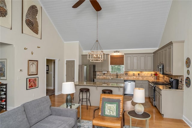 209 Falcon Crest Way, Pickens, SC 29671 - kitchen with appliances with stainless steel finishes, gray cabinets, backsplash, a ceiling fan, and a breakfast bar area