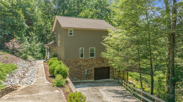 209 Falcon Crest Way, Pickens, SC 29671 - view of side of home featuring stone siding, concrete driveway, and an attached garage
