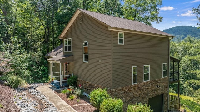 209 Falcon Crest Way, Pickens, SC 29671 - view of side of property with a sunroom, stone siding, and a shingled roof