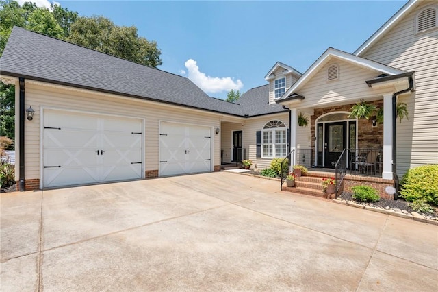220 Thomas Welborn Rd, Anderson, SC 29625 - view of front of home with driveway, a garage, covered porch, and roof with shingles