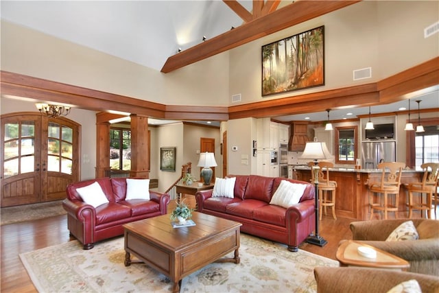 124 Pineridge Pointe Dr, Seneca, SC 29672 - living area featuring light wood-type flooring, french doors, a chandelier, and a high ceiling