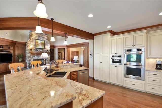 124 Pineridge Pointe Dr, Seneca, SC 29672 - kitchen with stainless steel appliances, light stone countertops, wood finished floors, and tasteful backsplash