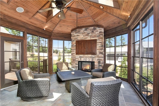 124 Pineridge Pointe Dr, Seneca, SC 29672 - sunroom featuring lofted ceiling, a skylight, ceiling fan, an outdoor living space with a fireplace, and a water view