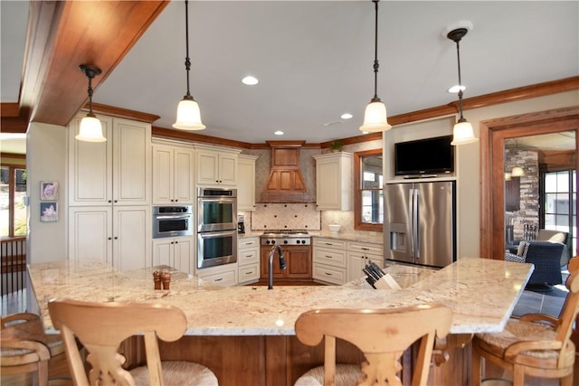 124 Pineridge Pointe Dr, Seneca, SC 29672 - kitchen featuring stainless steel appliances, custom exhaust hood, backsplash, a kitchen breakfast bar, and light stone countertops