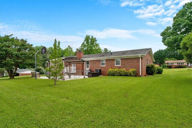 200 Camille St, Easley, SC 29642 - back of house featuring a yard, a patio, brick siding, and a chimney