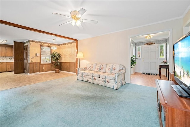 200 Camille St, Easley, SC 29642 - living area featuring carpet floors, a chandelier, ornamental molding, wood walls, and a wainscoted wall