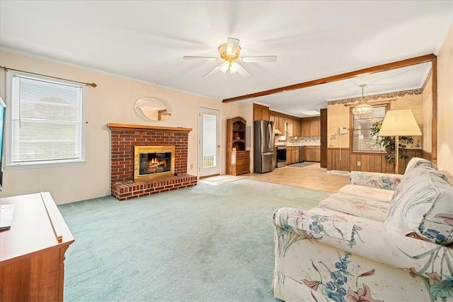 200 Camille St, Easley, SC 29642 - living room featuring ceiling fan, light carpet, a fireplace, ornamental molding, and beamed ceiling