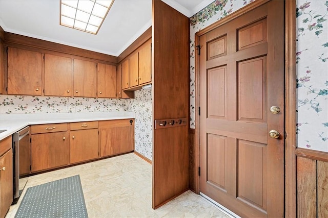 200 Camille St, Easley, SC 29642 - kitchen with wallpapered walls, stainless steel dishwasher, brown cabinets, light countertops, and crown molding
