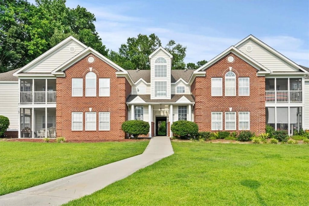 1189 Waxwing Dr Unit F, Florence, SC 29505 - multi unit property featuring brick siding, a front lawn, and a sunroom