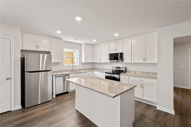 418 Kensington Cir Lot 19, Seneca, SC 29672 - kitchen featuring appliances with stainless steel finishes, white cabinets, a kitchen island, dark wood-type flooring, and recessed lighting