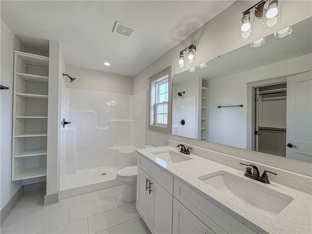 600 S Stribling St, Seneca, SC 29678 - bathroom featuring walk in shower, a spacious closet, double vanity, and tile patterned floors