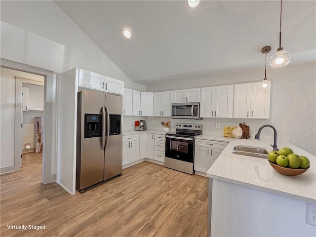 600 S Stribling St, Seneca, SC 29678 - kitchen with stainless steel appliances, light stone counters, light wood-style flooring, white cabinets, and decorative light fixtures
