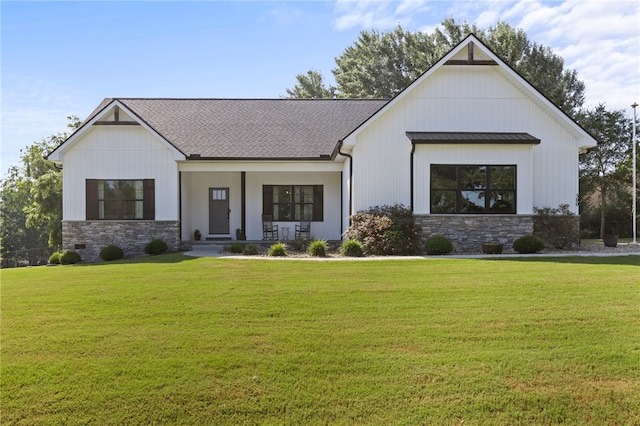 500 Serria Way, Seneca, SC 29678 - modern farmhouse style home featuring stone siding, covered porch, a standing seam roof, and a front lawn