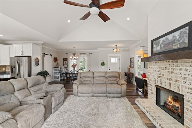 500 Serria Way, Seneca, SC 29678 - living room featuring a ceiling fan, dark wood-type flooring, a fireplace, a barn door, and vaulted ceiling