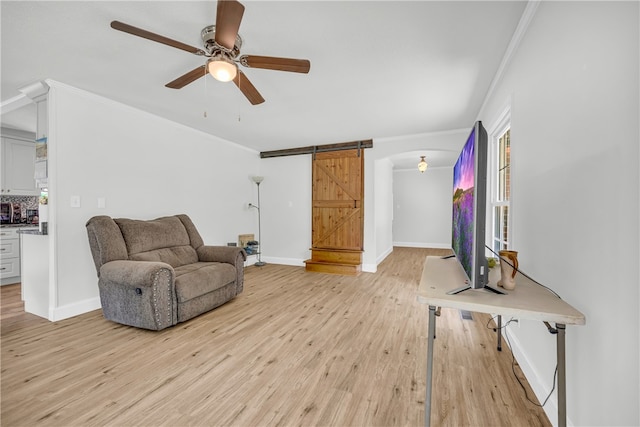 1399 Lake Jemiki Rd, Walhalla, SC 29691 - sitting room featuring light wood-type flooring, a ceiling fan, ornamental molding, a barn door, and arched walkways
