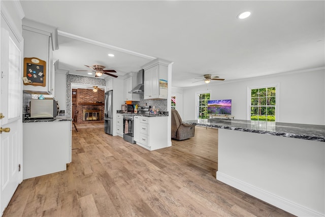 1399 Lake Jemiki Rd, Walhalla, SC 29691 - kitchen featuring ceiling fan, stainless steel appliances, a brick fireplace, wall chimney range hood, and recessed lighting