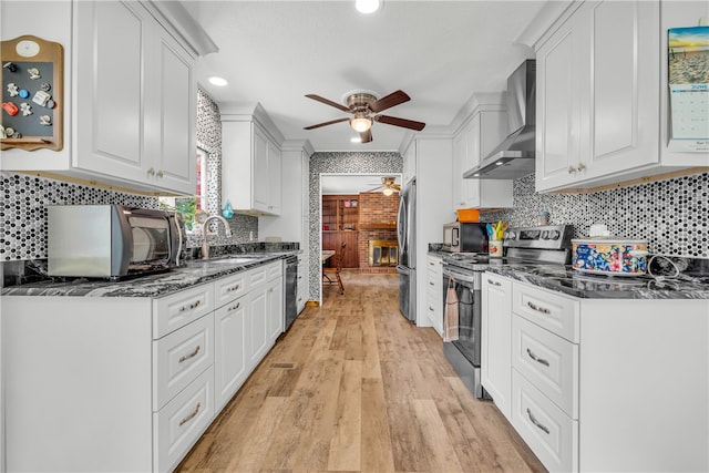 1399 Lake Jemiki Rd, Walhalla, SC 29691 - kitchen with appliances with stainless steel finishes, wall chimney exhaust hood, ceiling fan, white cabinets, and recessed lighting