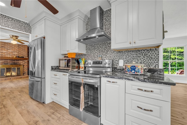 1399 Lake Jemiki Rd, Walhalla, SC 29691 - kitchen with wall chimney range hood, appliances with stainless steel finishes, a ceiling fan, and white cabinetry