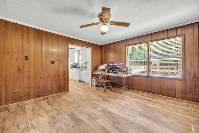1399 Lake Jemiki Rd, Walhalla, SC 29691 - home office featuring a ceiling fan, wooden walls, light wood finished floors, crown molding, and a textured ceiling