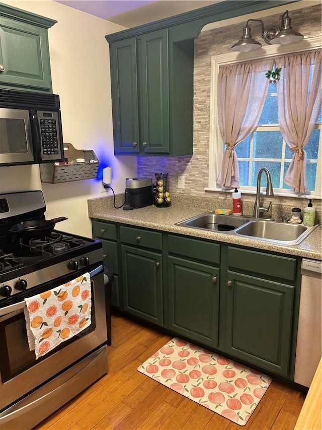 1430 W Main St, West Union, SC 29696 - kitchen featuring stainless steel appliances, green cabinets, light wood-style floors, and light countertops