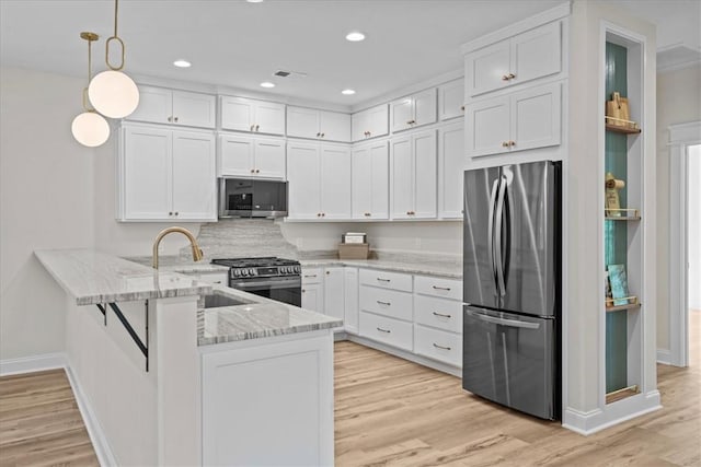 915 Coachmans Trl, West Union, SC 29696 - kitchen featuring appliances with stainless steel finishes, a peninsula, white cabinetry, light wood-type flooring, and recessed lighting