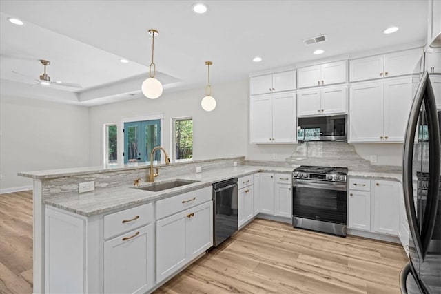 915 Coachmans Trl, West Union, SC 29696 - kitchen with stainless steel appliances, a peninsula, white cabinetry, recessed lighting, and light stone countertops