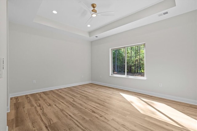 915 Coachmans Trl, West Union, SC 29696 - spare room with a tray ceiling, light wood-style flooring, recessed lighting, and ceiling fan