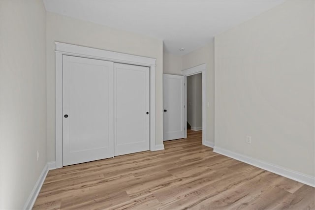 915 Coachmans Trl, West Union, SC 29696 - unfurnished bedroom with light wood-type flooring and a closet